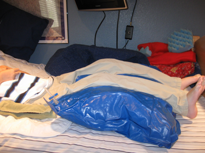 Side view of Brady lying on the bed with the VeraForm pillow under his legs