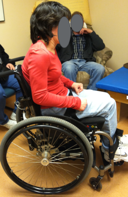 A young woman seated in a wheelchair for seated posture observation