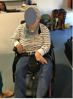 An older woman seated in a wheelchair as an example of seated posture