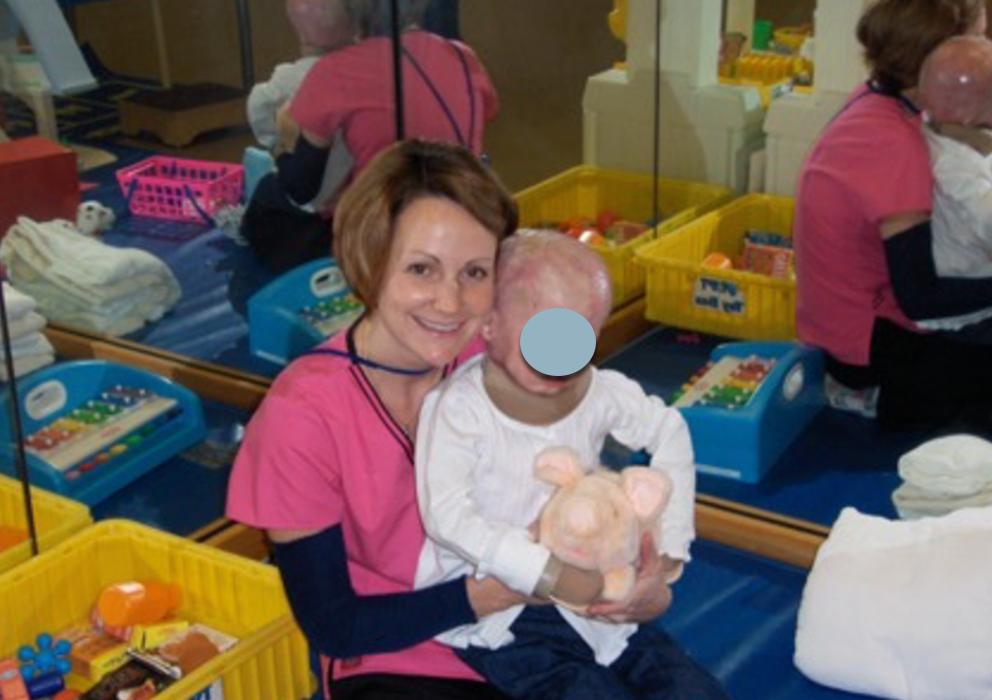 Patti at Shriners Hospital with a child 