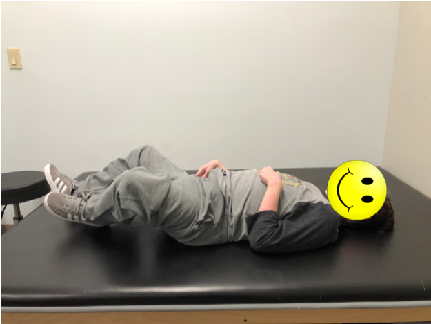 Boy lying supine on mat