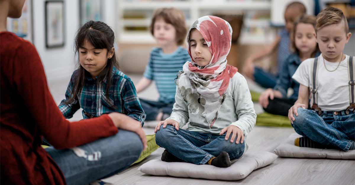 Group of children sitting with their eyes closed