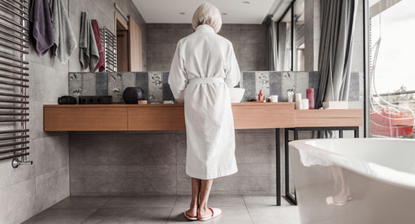 Woman standing at the sink in a bathroom